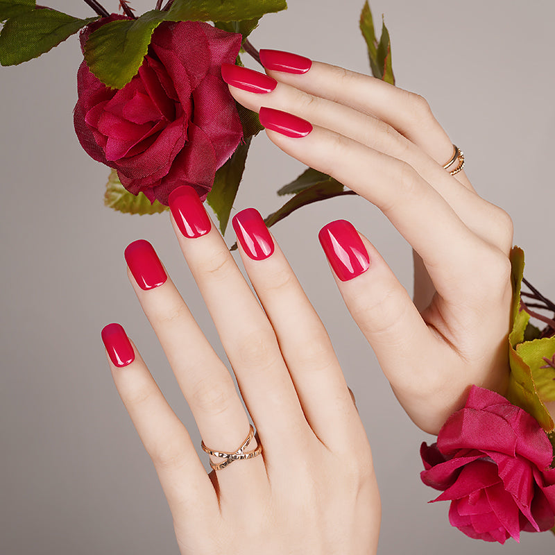 Classic bright red gel nails on hands, achieved with a DIY semi-cured sticker kit for a bold, glamorous, and long-lasting manicure.