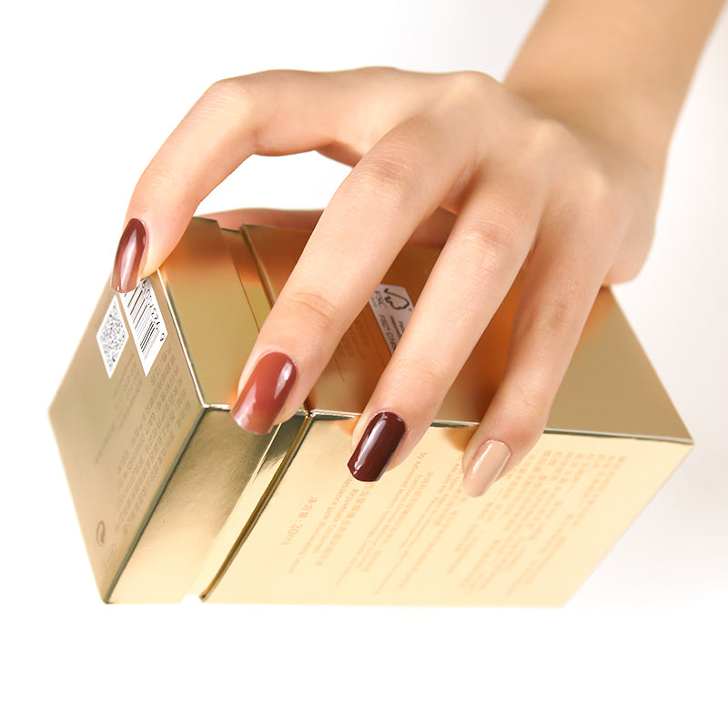 Rich warm brown nails on natural hands, achieved with a DIY semi-cured gel sticker kit for a cozy, sophisticated manicure.