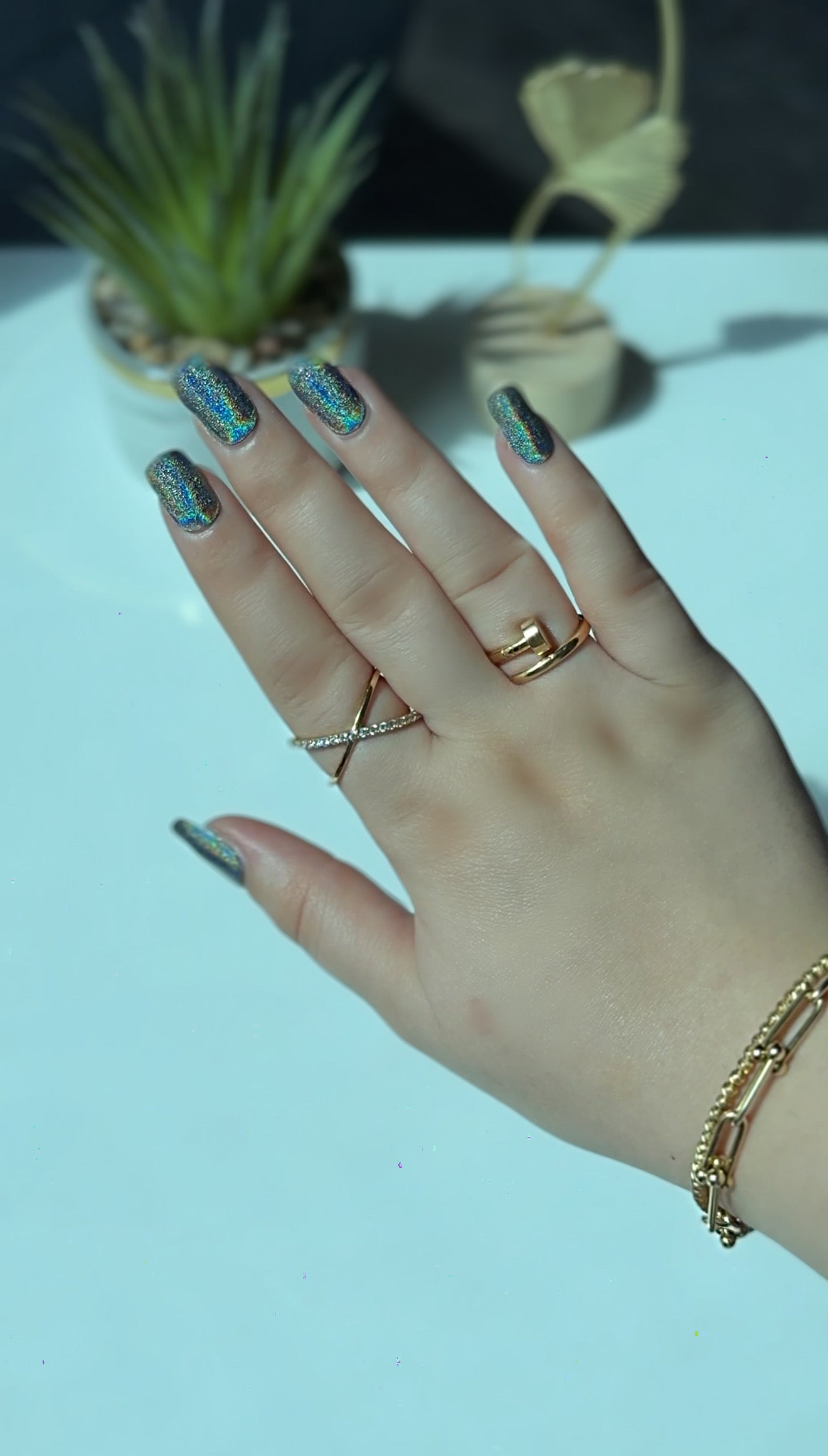 Modern abstract blue and gold oval nails on hands, featuring a stylish color-block design achieved with a DIY semi-cured gel sticker kit.