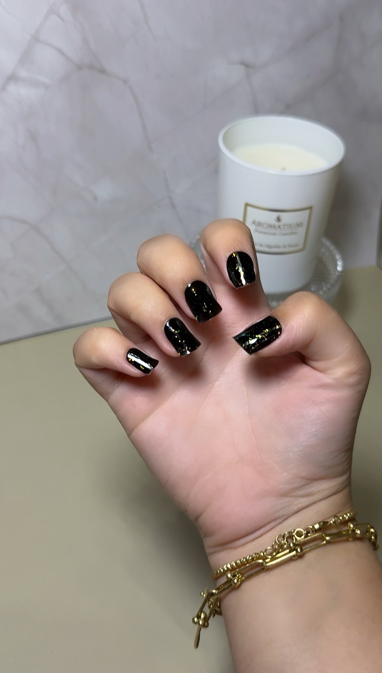 Trendy bohemian speckle nail art on natural hands, created with a DIY semi-cured gel sticker kit for an artistic, free-spirited