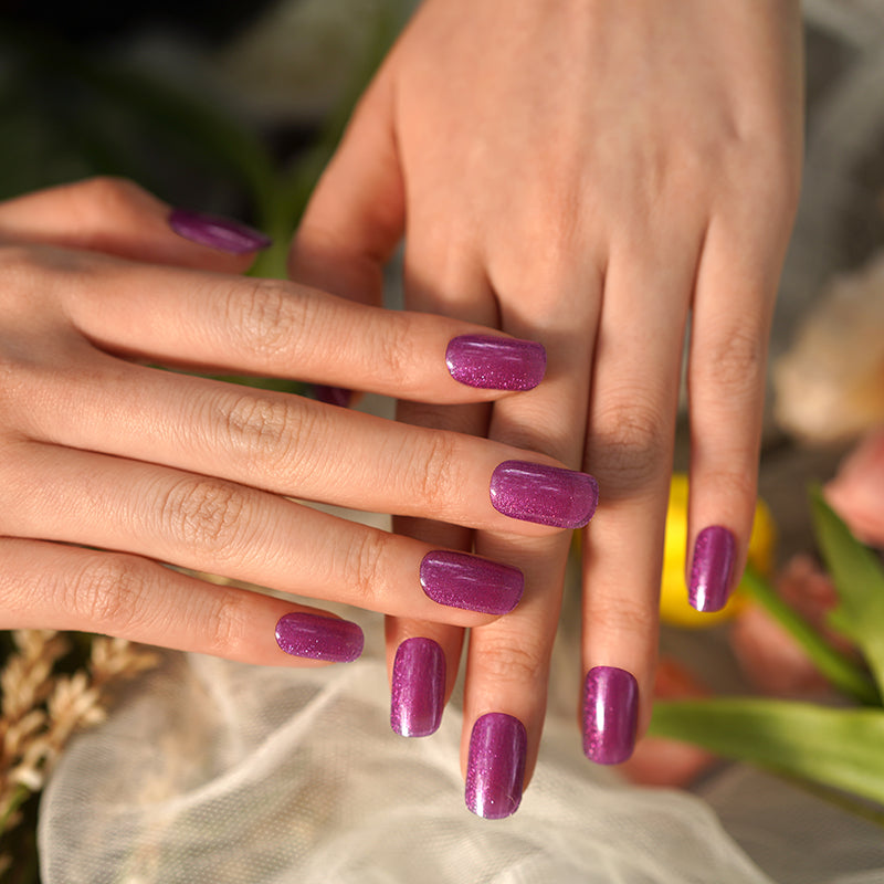 Luminous lavender pearlescent nails on hands, created with a DIY semi-cured gel sticker kit for a soft, shimmery, and elegant manicure.